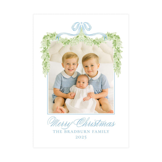 A family portrait of two young boys and a baby, with a decorative border and text at the bottom.