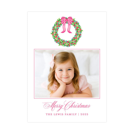 A young girl with a bow in her hair is smiling at the camera, with a wreath above her and a personalized message below.