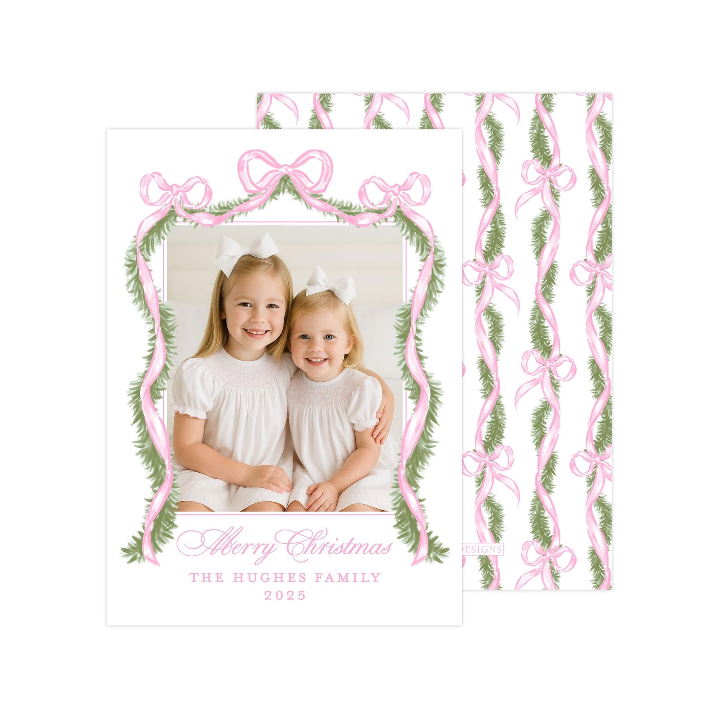 A Christmas card featuring two young girls in white dresses, smiling and posing together. The card has a pink and green floral border and a bow design, and includes a message that reads "Merry Christmas The HUGGES FAMILY 2015".