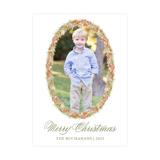 A young boy in a blue shirt and khaki pants stands in a floral wreath frame, with the text "Merry Christmas" and "THE BACHANS | 2025" below the frame.