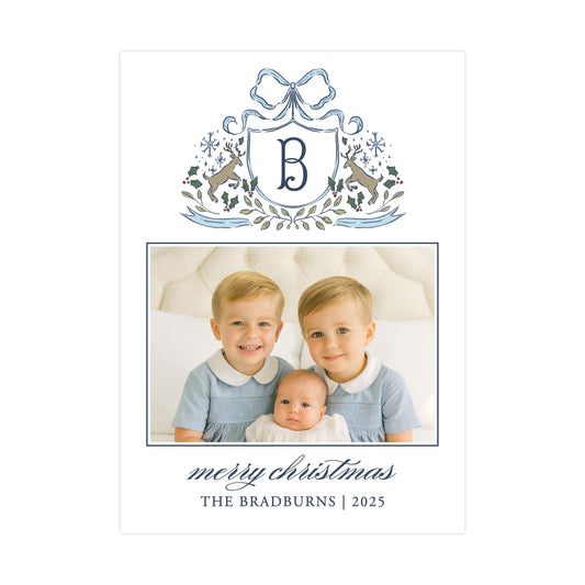 A family portrait of two young boys and a baby, with a decorative border and a monogrammed letter "B" above them. The caption below the image reads "mercy christmas THE BRADBURNS | 2025".