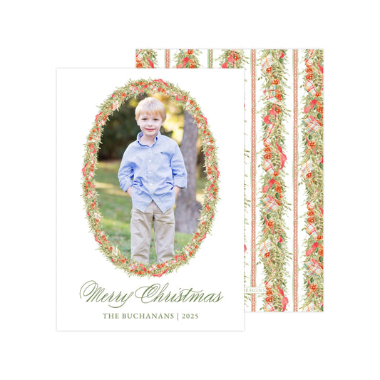 A young boy in a blue shirt stands in a wreath of flowers, smiling at the camera. The text "Merry Christmas" and "THE BUCANANS | 2025" is displayed below the photo.