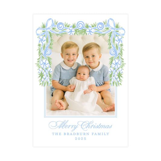 A family portrait of two young boys and a baby, with a decorative border and text at the bottom.