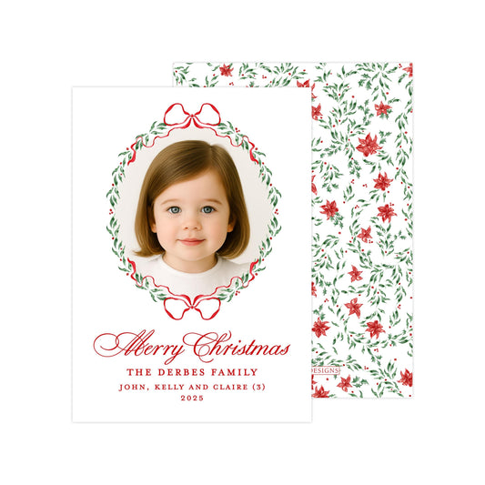 A Christmas card featuring a young girl's portrait in the center, surrounded by a wreath design and red and green floral patterns. The card includes a message wishing the recipient a Merry Christmas and includes the names John, Kelly, and Claire.