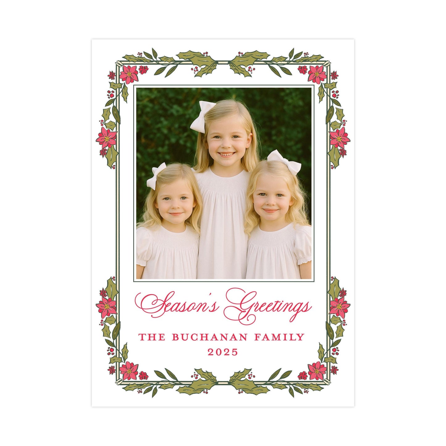 A family portrait of three young girls in white dresses, with a floral border around the edges. The text below the photo reads &quot;Season&#39;s Greetings The Buchanan Family 2025&quot;.