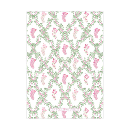 a repeating pattern of pink and green floral designs, including small pink and green socks, arranged in a grid-like pattern.