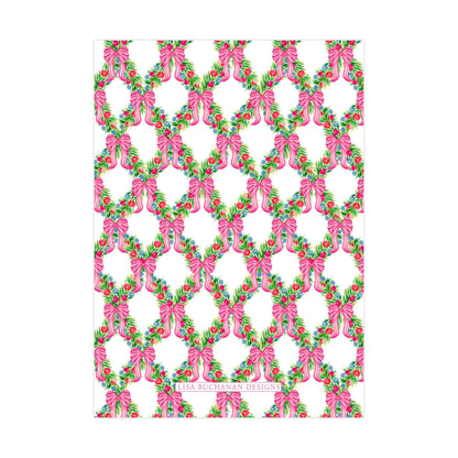 a repeating pattern of pink bows and green leaves on a white background.