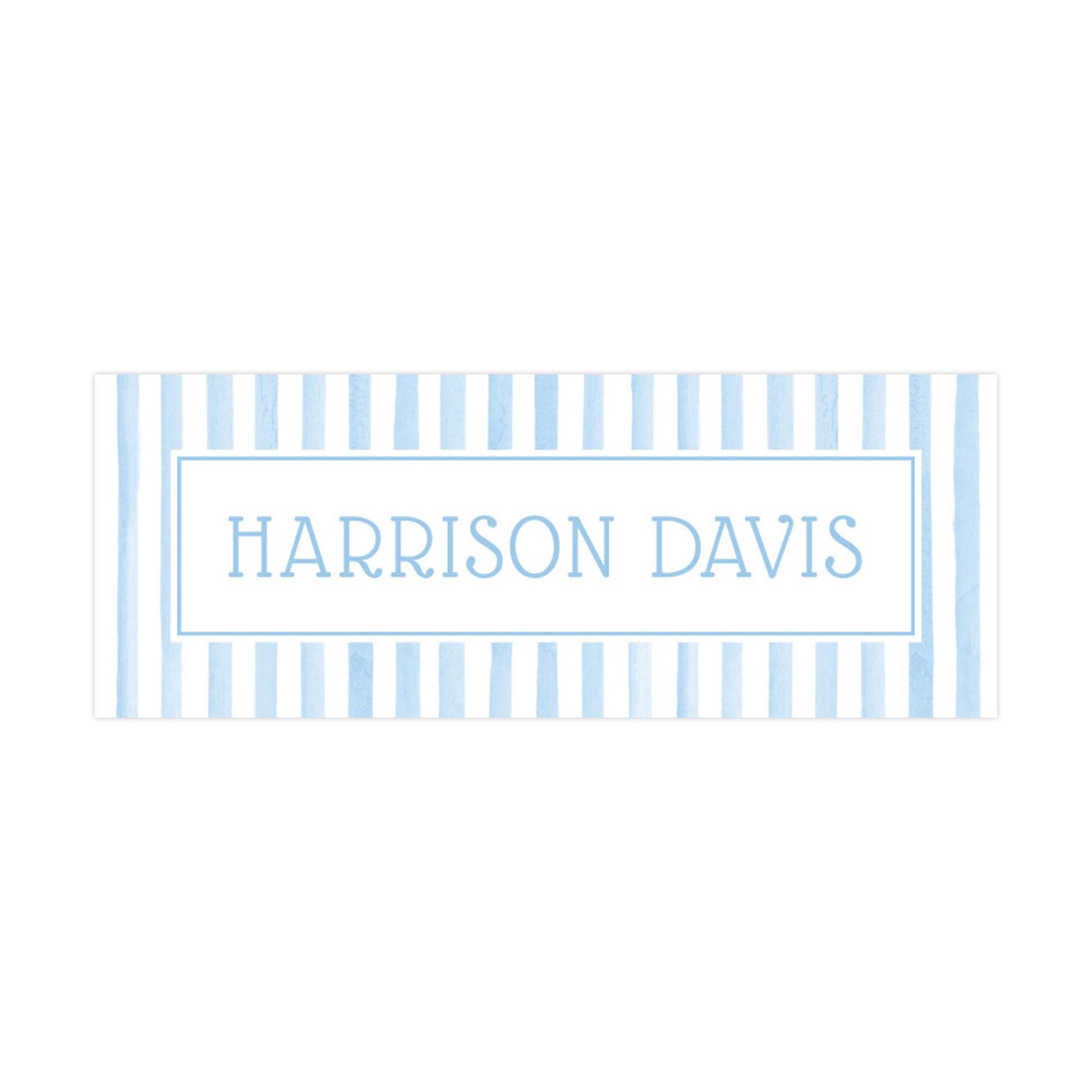 A rectangular sign with the name &quot;HARRISON DAVIS&quot; written in a blue and white striped pattern.