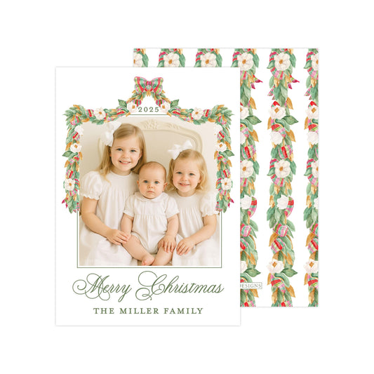 A family photo of three young girls, likely sisters, sitting together and smiling for a Christmas card.
