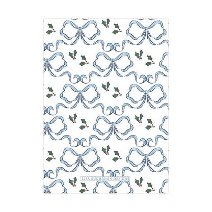 a repeating pattern of blue bows and holly leaves on a white background.