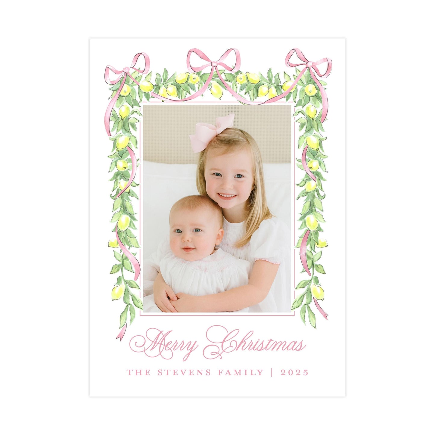A young girl and a baby are sitting together in a frame, surrounded by a decorative border of lemons and pink ribbons. The text &quot;Merry Christmas&quot; is written in a cursive font at the bottom of the image.