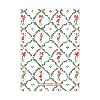 a repeating pattern of Christmas stockings and holly leaves on a white background.