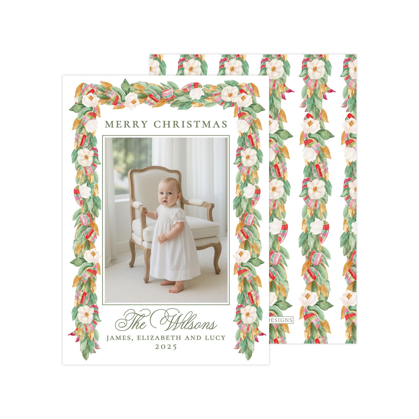A holiday card featuring a baby girl in a white dress, with a floral border and text that reads &quot;Merry Christmas The Wilson&#39;s James, Elizabeth and Lucy 2015&quot;.