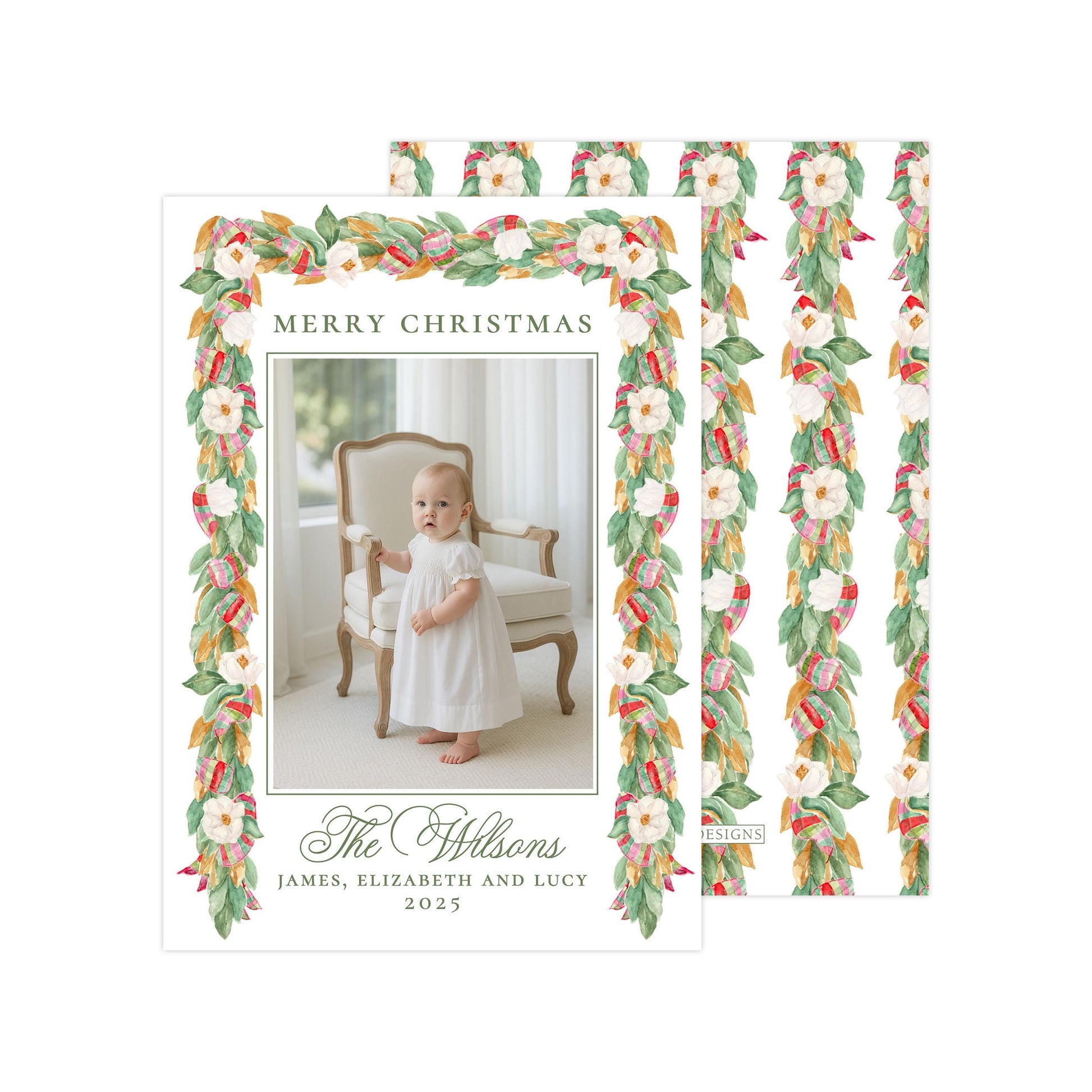 A holiday card featuring a baby girl in a white dress, with a floral border and text that reads &quot;Merry Christmas The Wilson&#39;s James, Elizabeth and Lucy 2015&quot;.