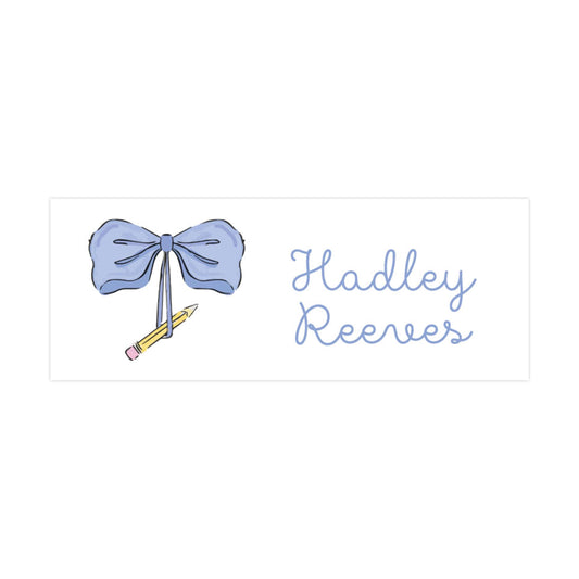 a blue bow tie and a pencil, with the name &quot;Hadley Reeves&quot; written in cursive below them.