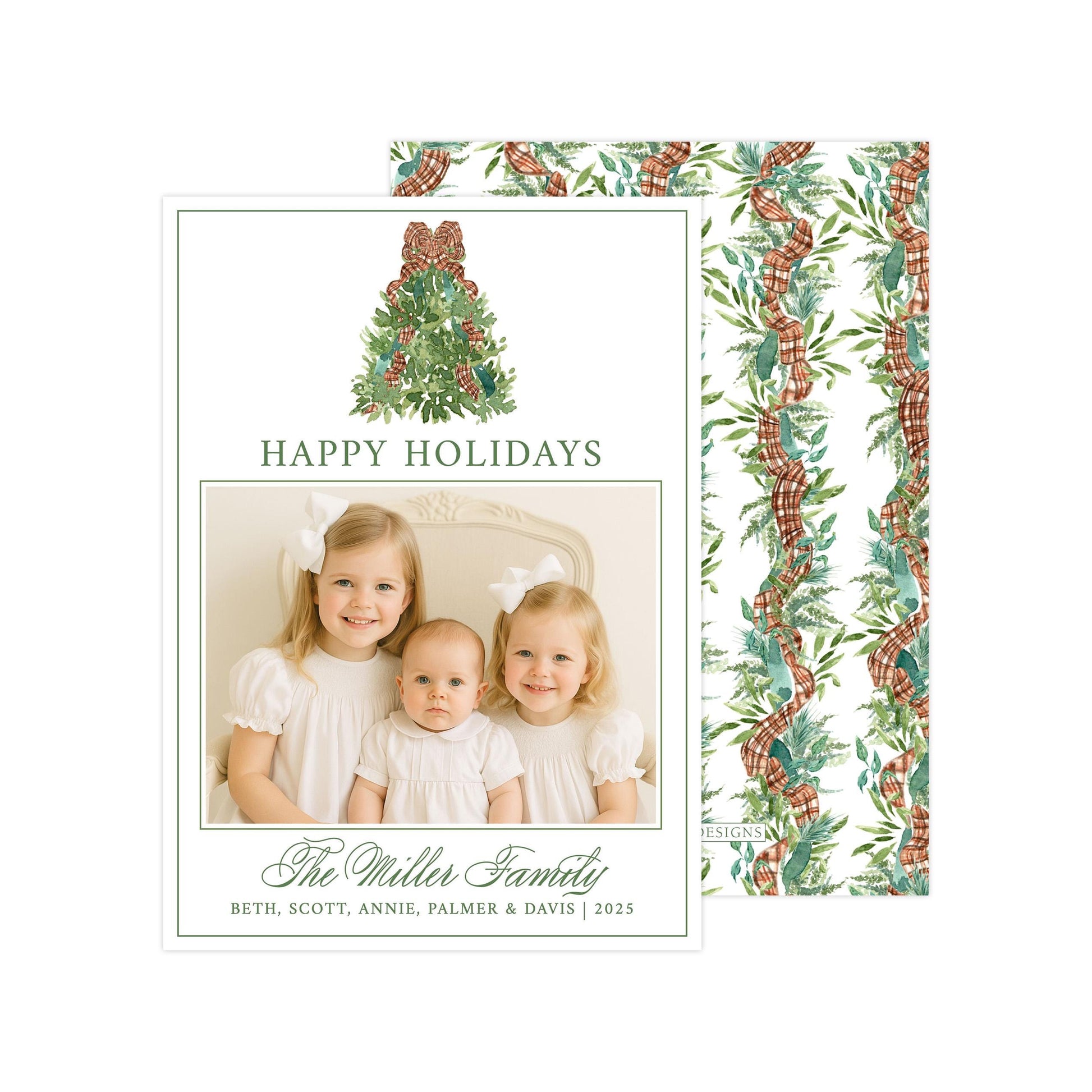 A holiday card featuring three young girls in white dresses, with a Christmas tree and ribbon design. The card has a festive and cheerful design with the text &quot;Happy Holidays&quot; and &quot;The Miller Family&quot; written on it.