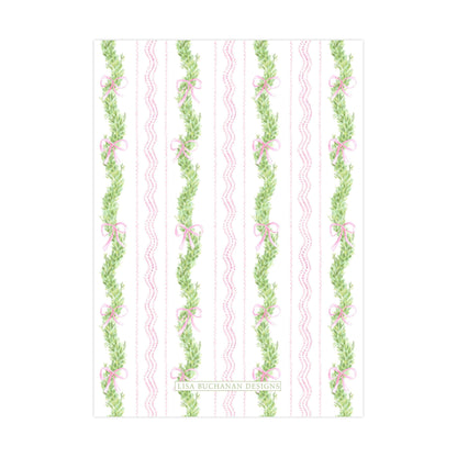 a repeating pattern of green leaves and pink bows on a white background.