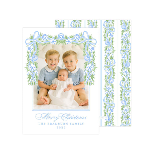A family portrait of three children, two boys and a girl, sitting together and smiling. The image is framed by a decorative border with blue and green floral patterns. The text at the bottom of the image reads &quot;Al Merry Christmas The Bradburn Family 2015&quot;.