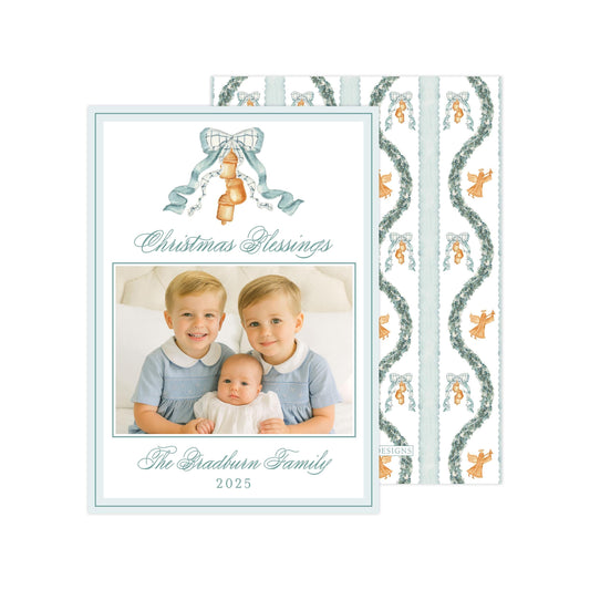A Christmas card featuring a family portrait of two children and a baby, with a patterned background and a ribbon design.