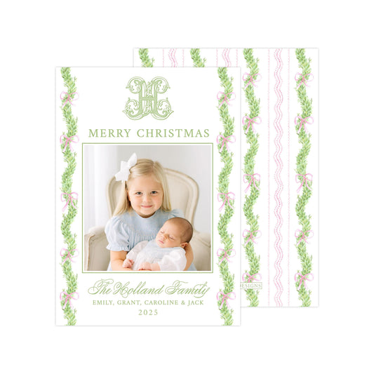 The image is a Christmas card featuring a young girl holding a baby. The card has a floral border and the text &quot;Merry Christmas&quot; and &quot;The Highland Family&quot; written on it.