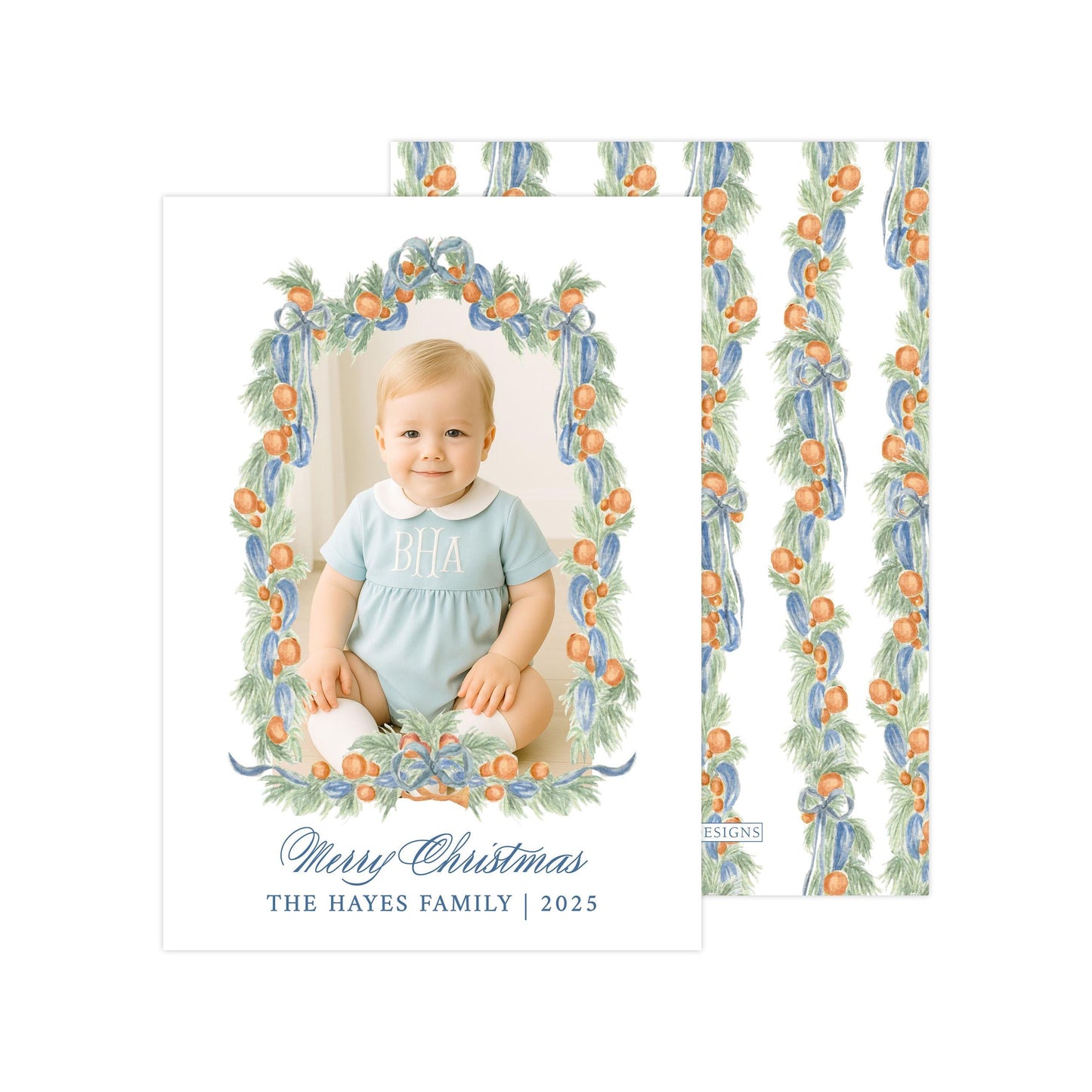 A photo of a smiling baby wearing a blue outfit, surrounded by a wreath of orange and green leaves. The text below the image reads "Merry Christmas THE HAYES FAMILY | 2025".