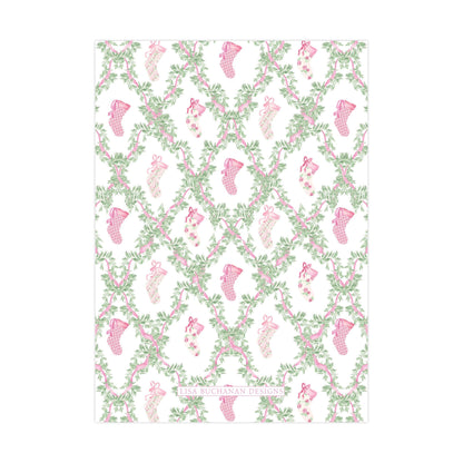 a repeating pattern of pink and green floral designs, including small pink and green socks, arranged in a grid-like pattern.