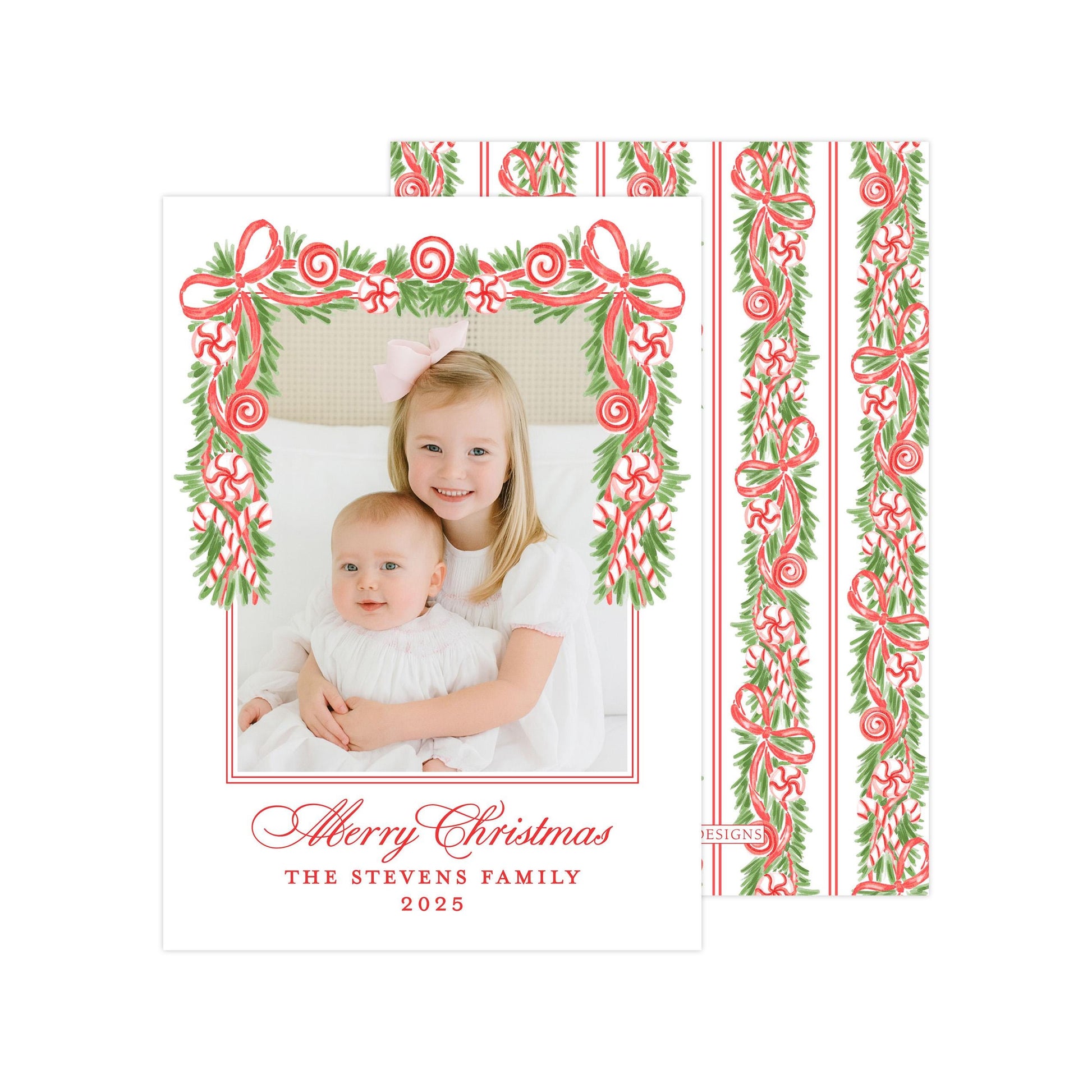 A Christmas card featuring two young girls, one wearing a white dress and the other in a white outfit, with a festive border of red and green ribbons and greenery. The card has a personalized message and year, and the image is described as a collage of multiple images.