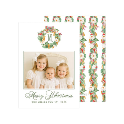 A family photo of three young girls, likely sisters, smiling and posing together. The photo is framed with a wreath design and the text &quot;Merry Christmas&quot; and &quot;The Miller Family | 2025&quot; is displayed below the photo.