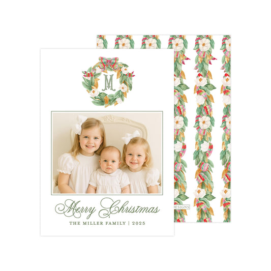 A family photo of three young girls, likely sisters, smiling and posing together. The photo is framed with a wreath design and the text &quot;Merry Christmas&quot; and &quot;The Miller Family | 2025&quot; is displayed below the photo.