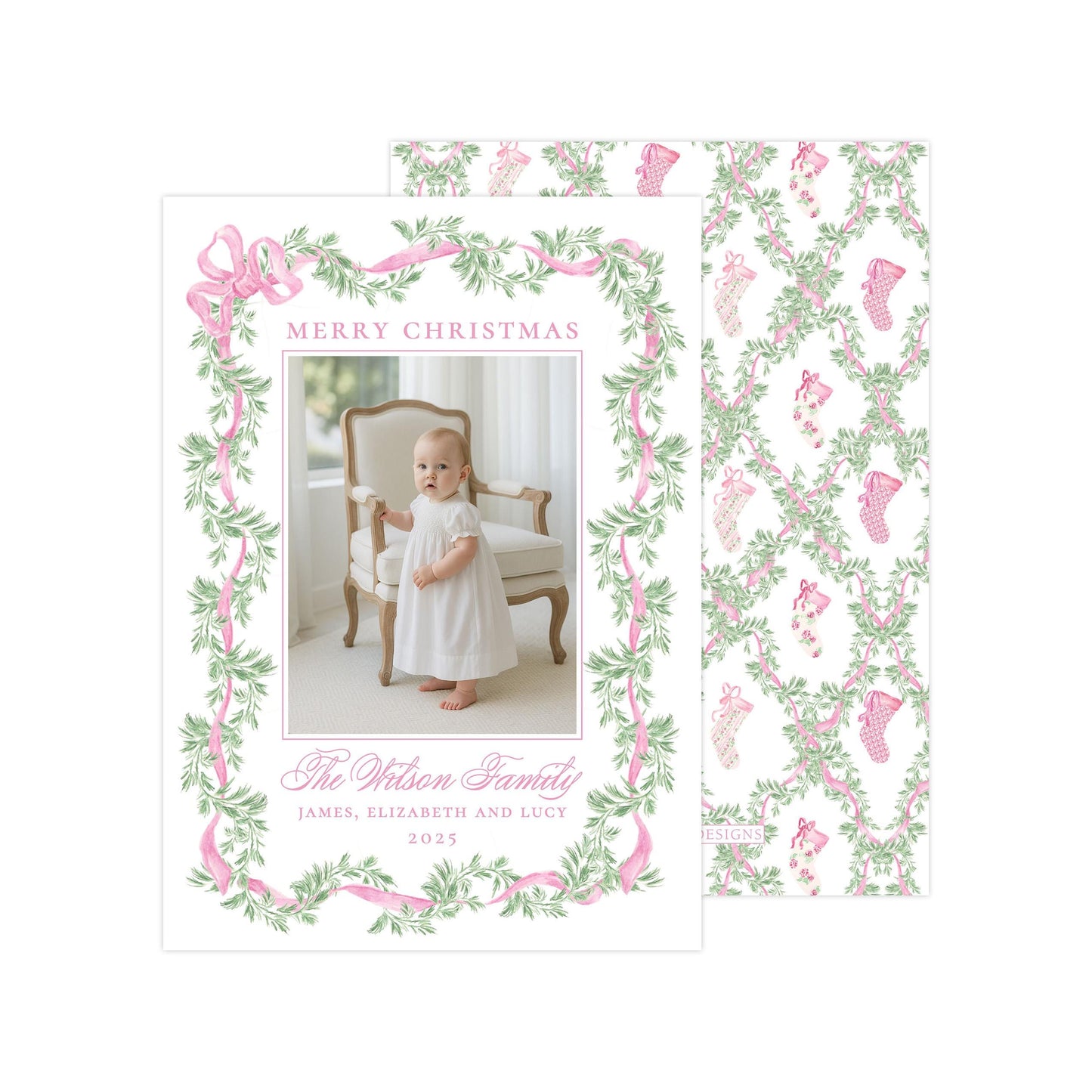 The image is a Christmas card featuring a baby girl in a white dress, surrounded by a pink and green floral border. The card has a festive design with a pattern of pink and green leaves and stockings. The text on the card reads &quot;Merry Christmas&quot; and &quot;The Wilson Family&quot;, along with the names &quot;James, Elizabeth and Lucie&quot; and the year &quot;2023&quot;.